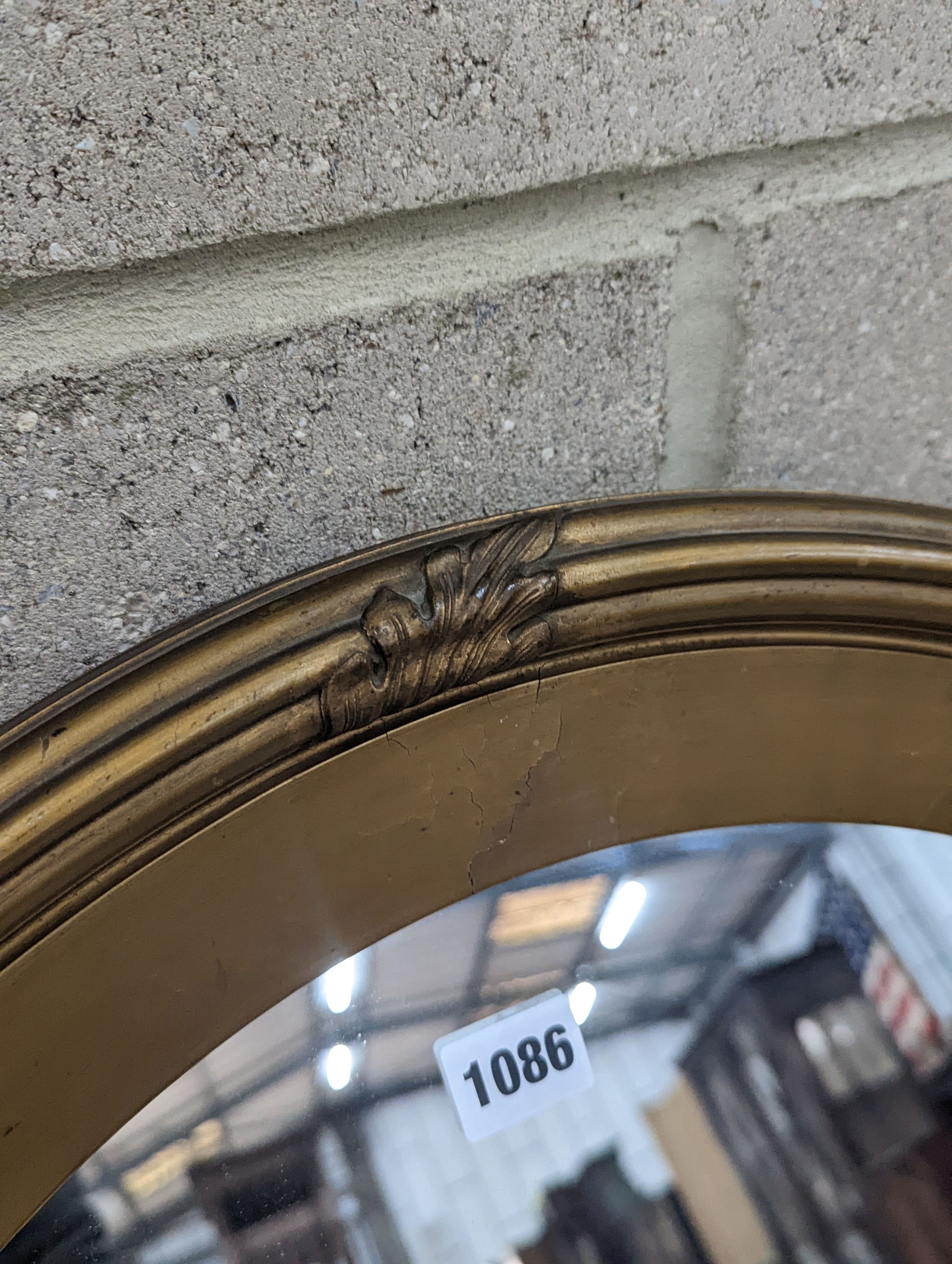 An Edwardian oval gilt framed wall mirror, width 72cm, height 87cm